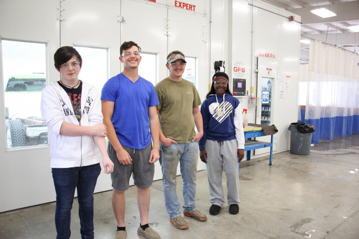 Collision Repair and Refinishing Technology students in front of the paint booth