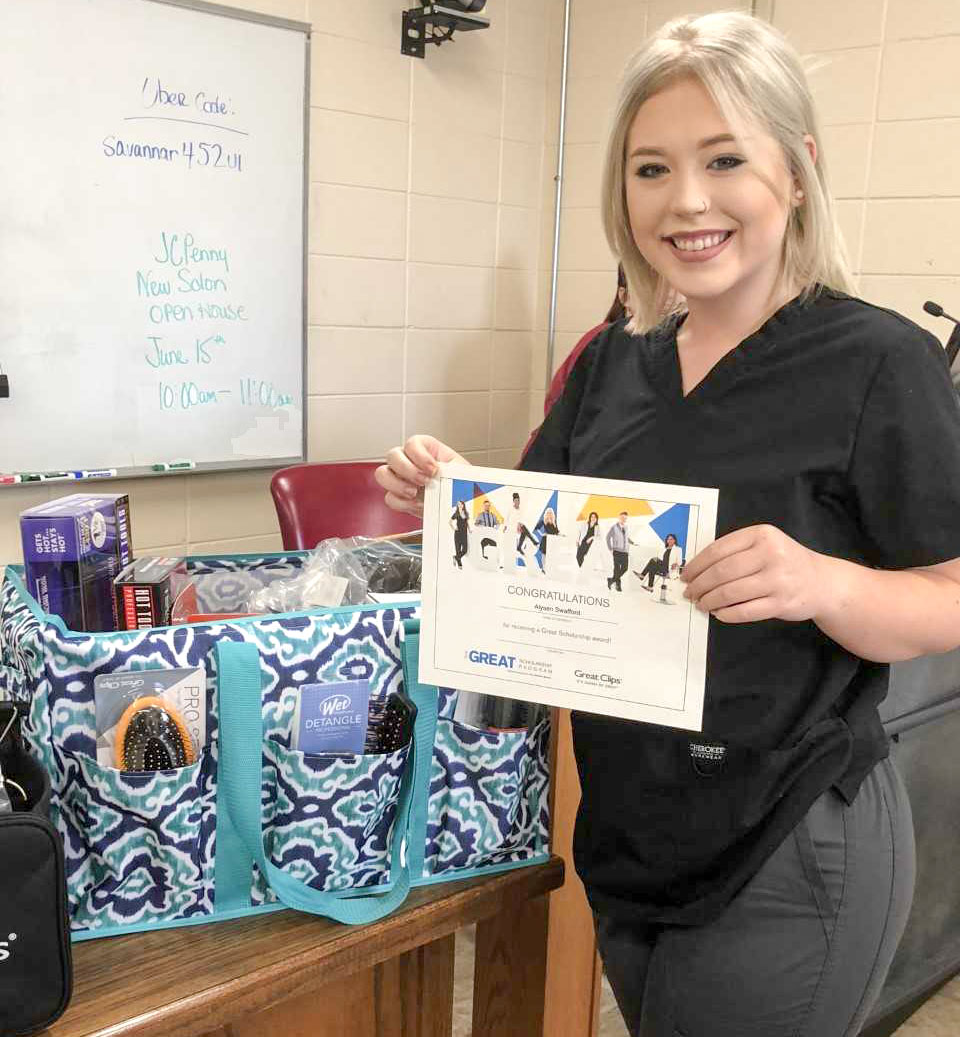 Alysen Swafford pictured with her certificate and other products awarded to her from Great Clips.