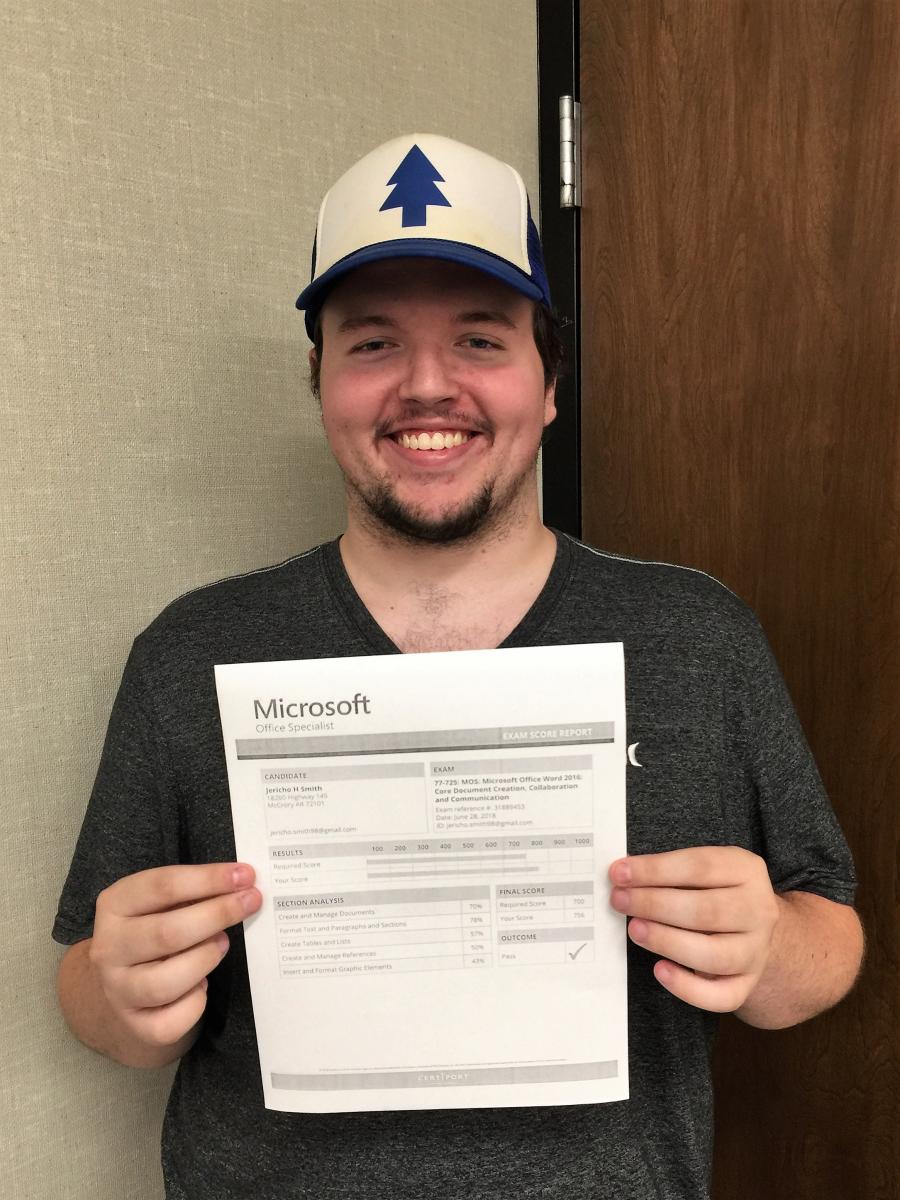 Jericho Smith standing with his Microsoft certification.